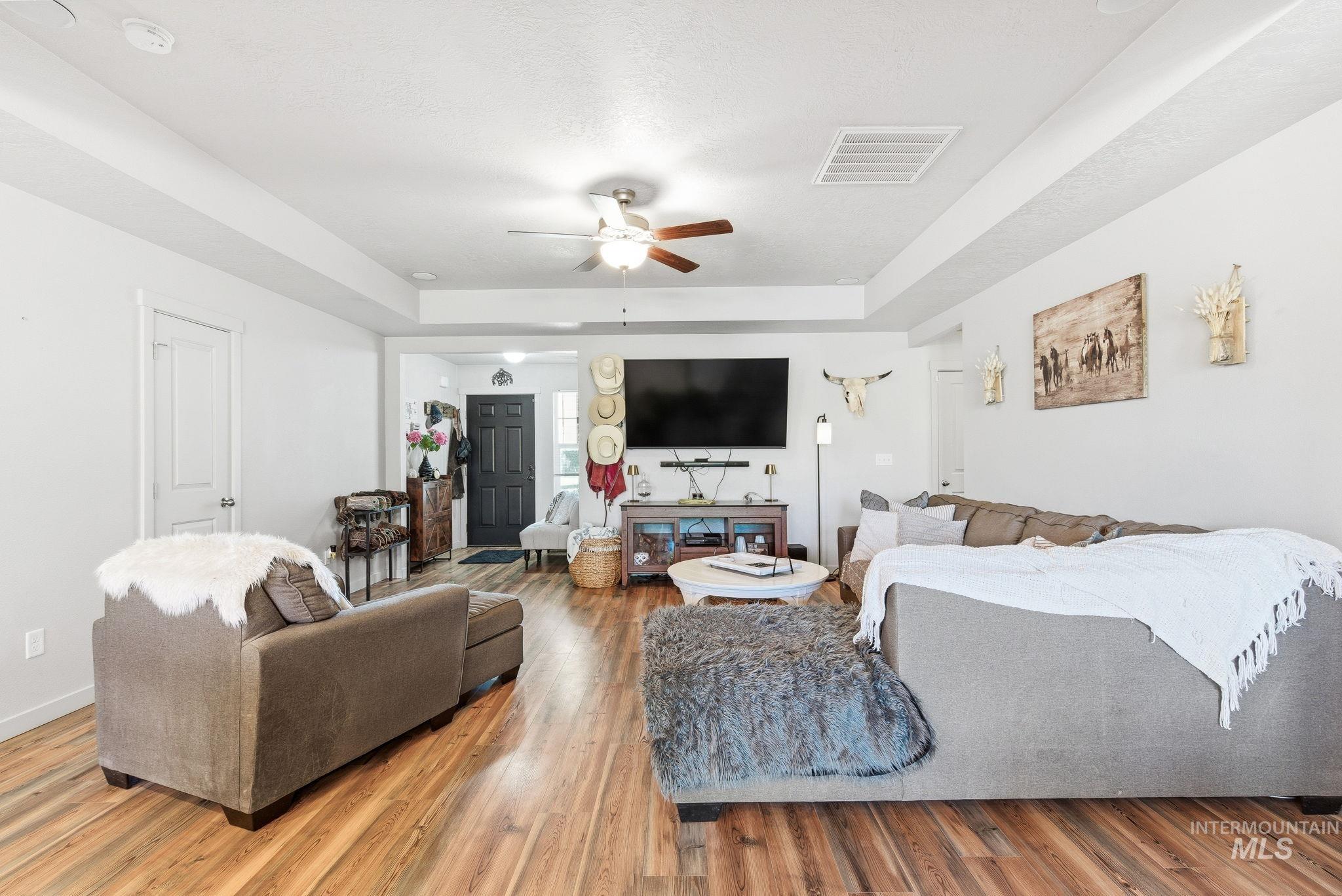 16887 Bethany Avenue Caldwell, ID 83607 - Photo 12 of 50 Spacious living area featuring wood-finish flooring, a recessed ceiling, and a ceiling fan with integrated lighting