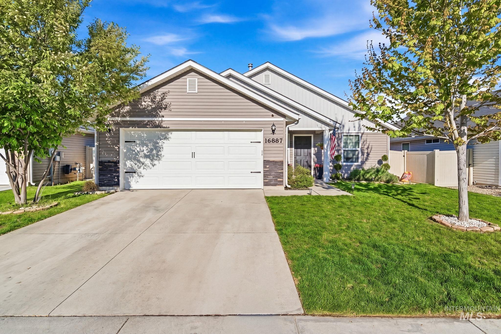 16887 Bethany Avenue Caldwell, ID 83607 - Photo 2 of 50 Single-story property with a two-car garage, concrete driveway, and a manicured front lawn