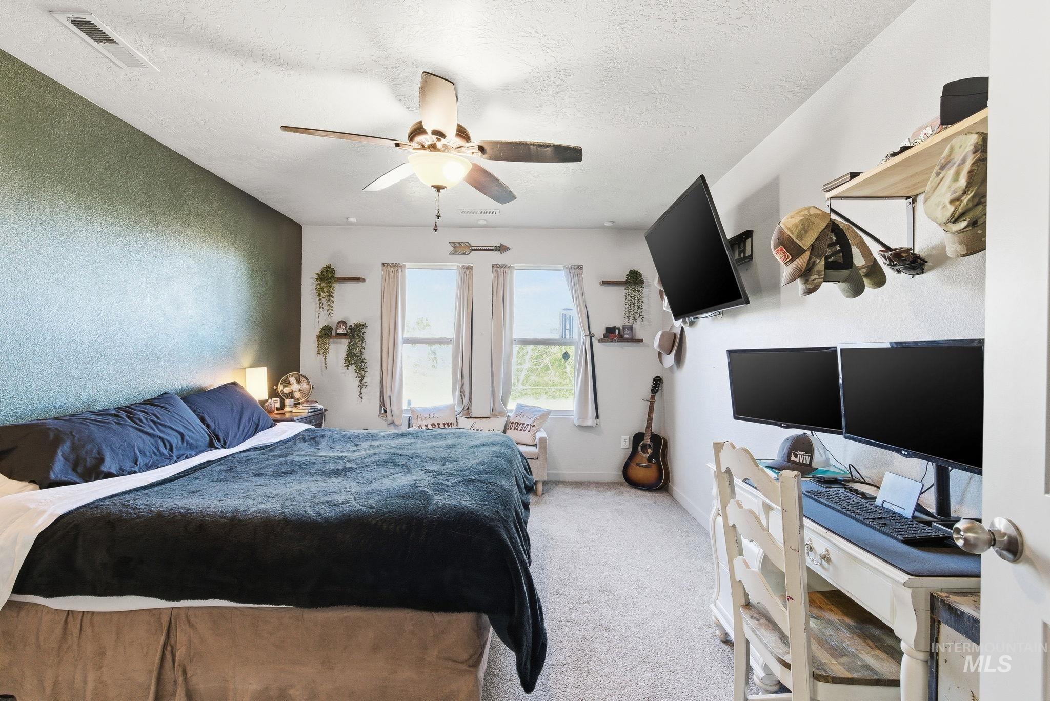 16887 Bethany Avenue Caldwell, ID 83607 - Photo 24 of 50 Spacious room with dual windows, overhead ceiling fan, and carpet flooring