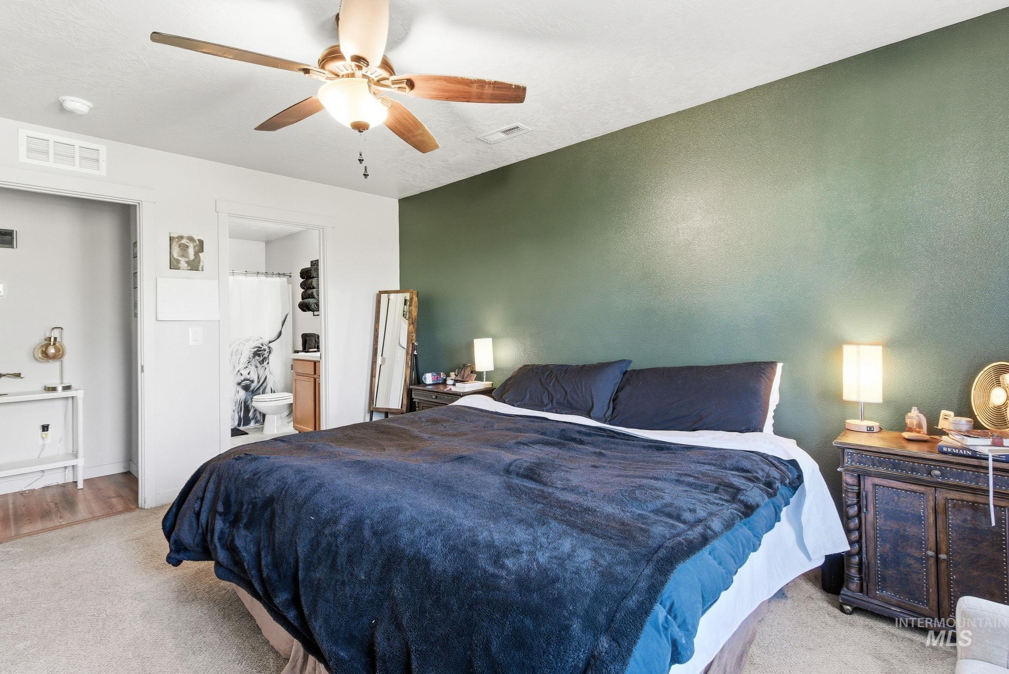 16887 Bethany Avenue Caldwell, ID 83607 - Photo 26 of 50 Bedroom featuring a dark green accent wall and light-toned carpeting