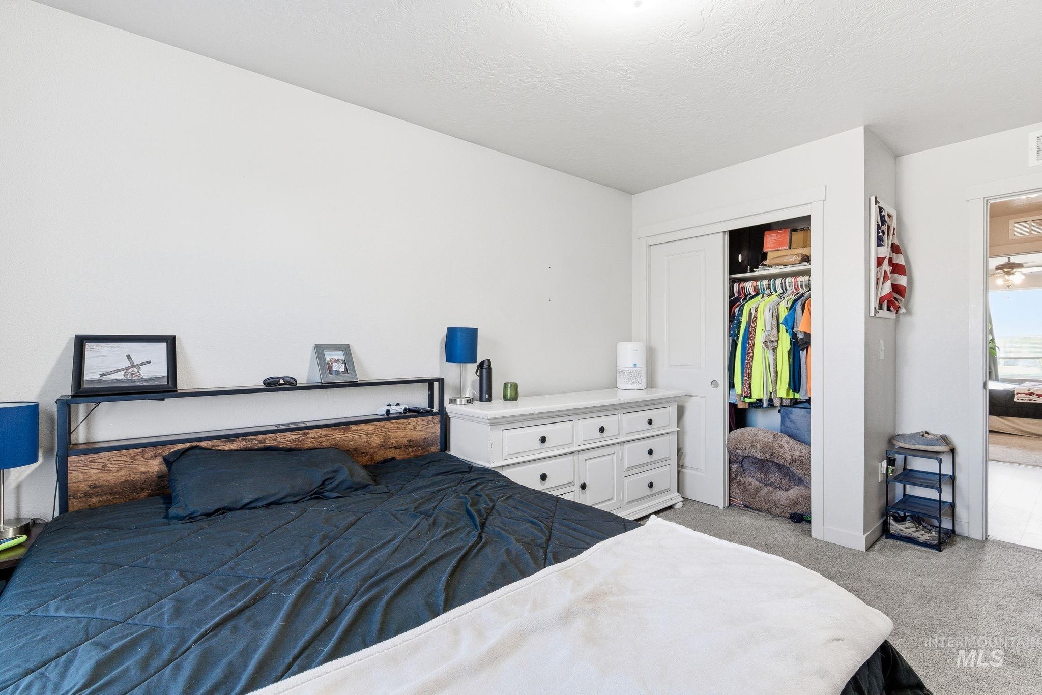 16887 Bethany Avenue Caldwell, ID 83607 - Photo 28 of 50 Carpeted bedroom featuring white painted walls and a built-in closet with sliding doors