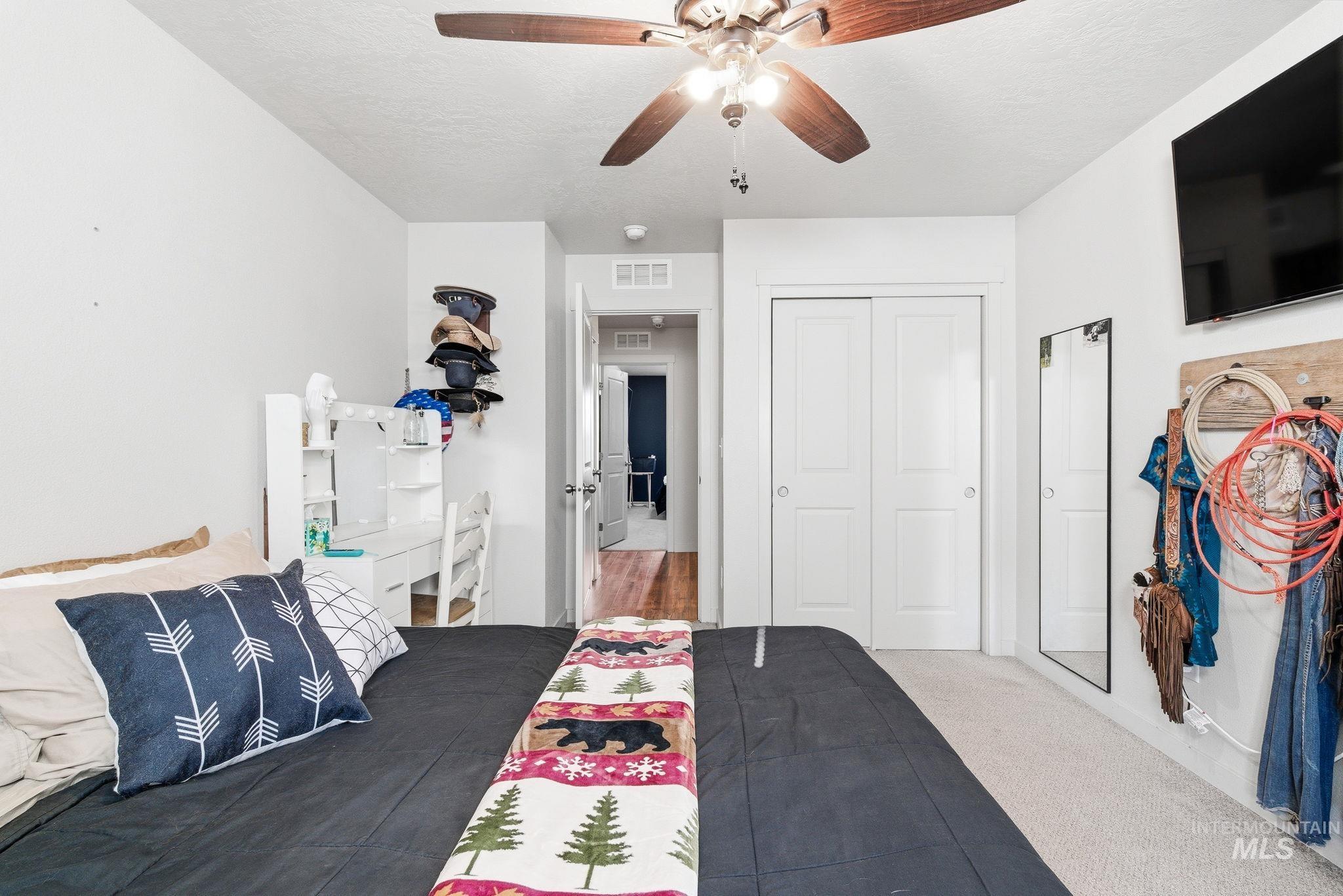 16887 Bethany Avenue Caldwell, ID 83607 - Photo 30 of 50 Bedroom featuring a ceiling fan with integrated lighting, neutral wall paint, and plush carpeting