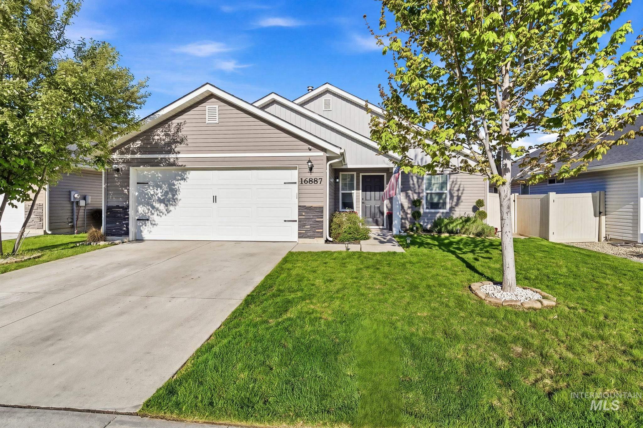 16887 Bethany Avenue Caldwell, ID 83607 - Photo 3 of 50 Contemporary residence featuring a two-car garage, concrete driveway, and a front entry with a small porch
