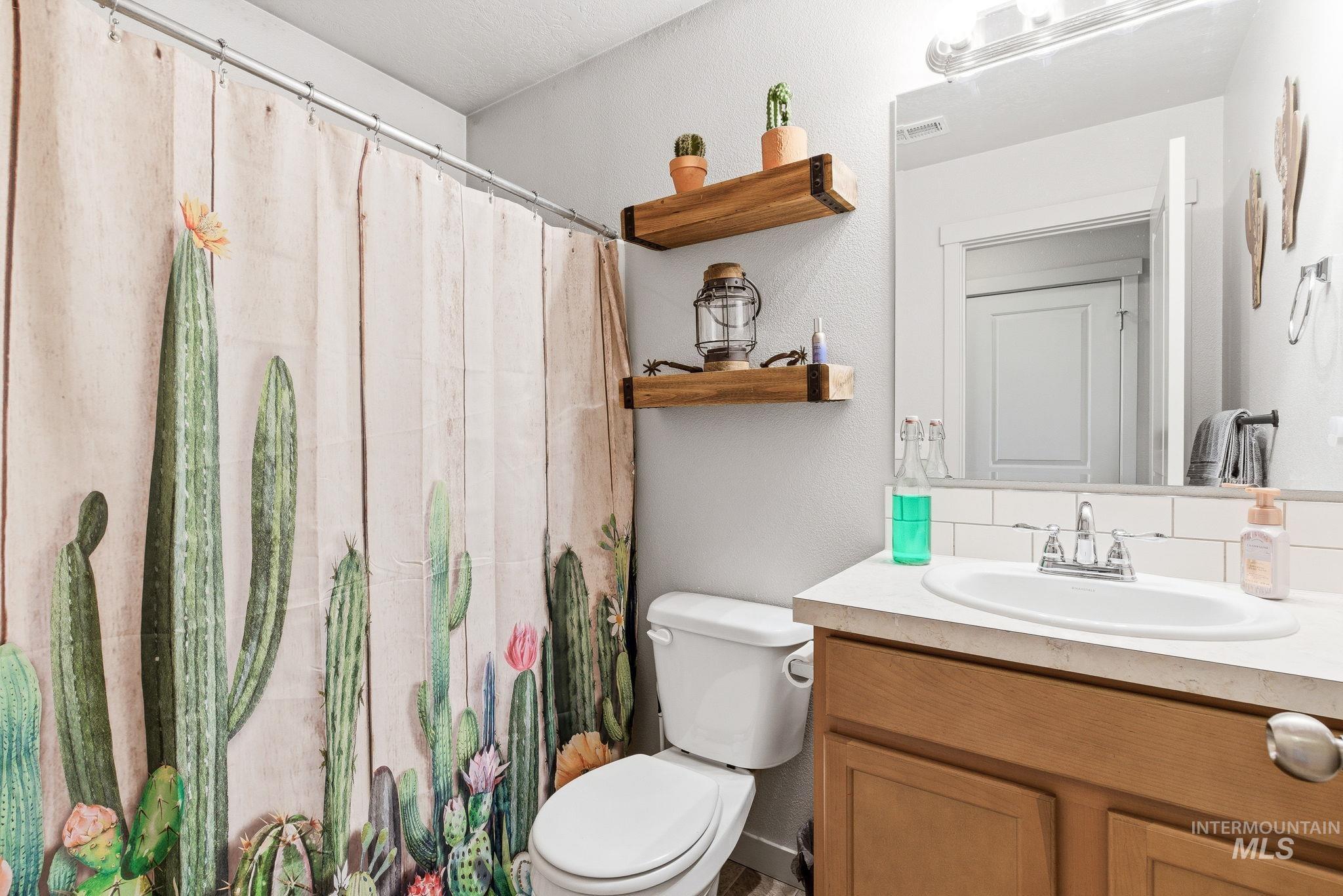 16887 Bethany Avenue Caldwell, ID 83607 - Photo 34 of 50 Bathroom with a light-toned vanity, integrated sink, and white subway tile backsplash
