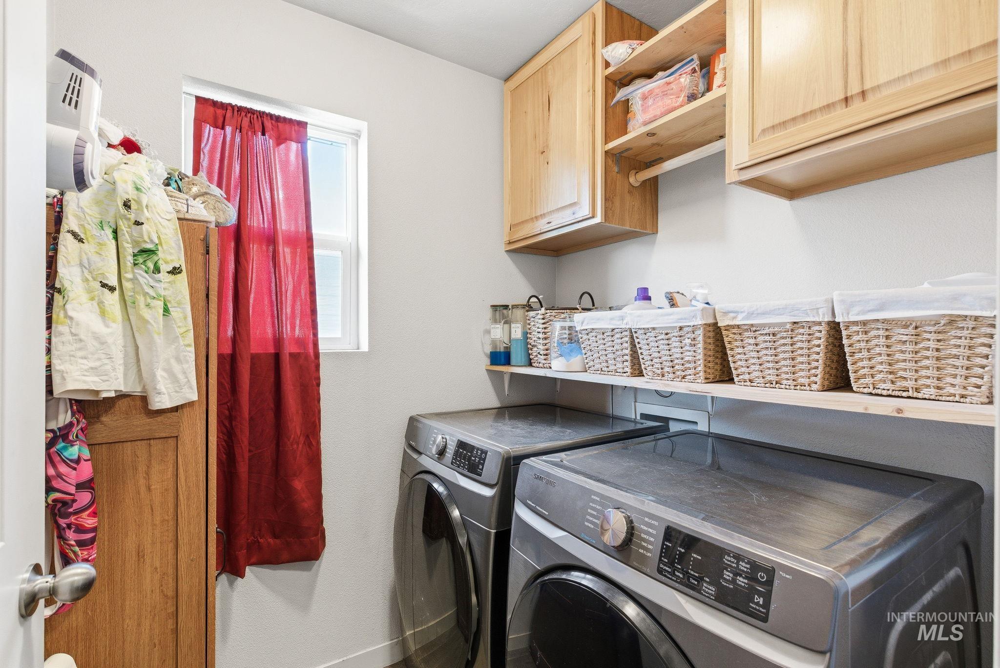 16887 Bethany Avenue Caldwell, ID 83607 - Photo 35 of 50 Dedicated laundry area featuring a window, light wood cabinetry, open shelving, and light gray walls