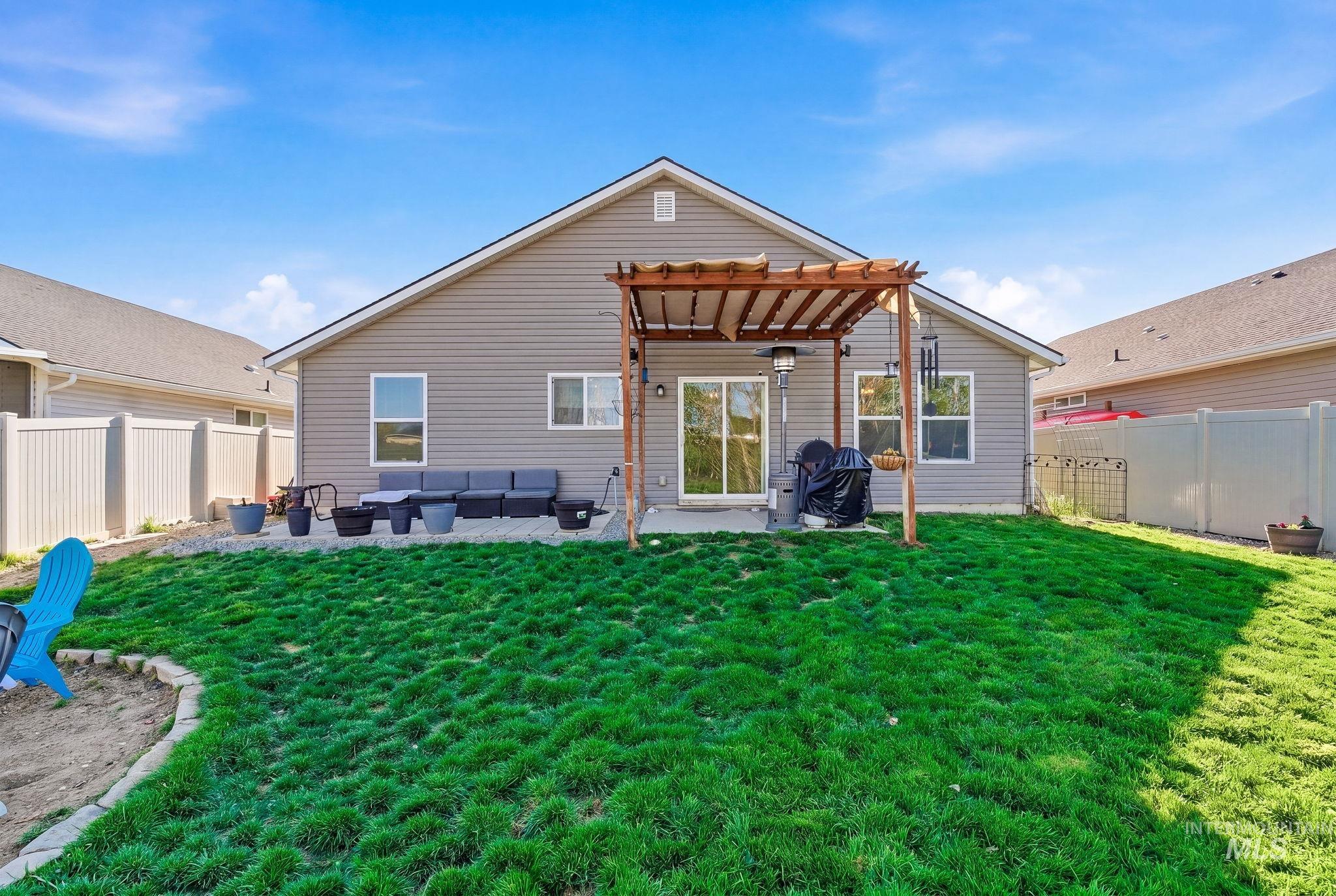 16887 Bethany Avenue Caldwell, ID 83607 - Photo 44 of 50 Expansive backyard featuring a manicured lawn, a concrete patio, and a wooden pergola structure