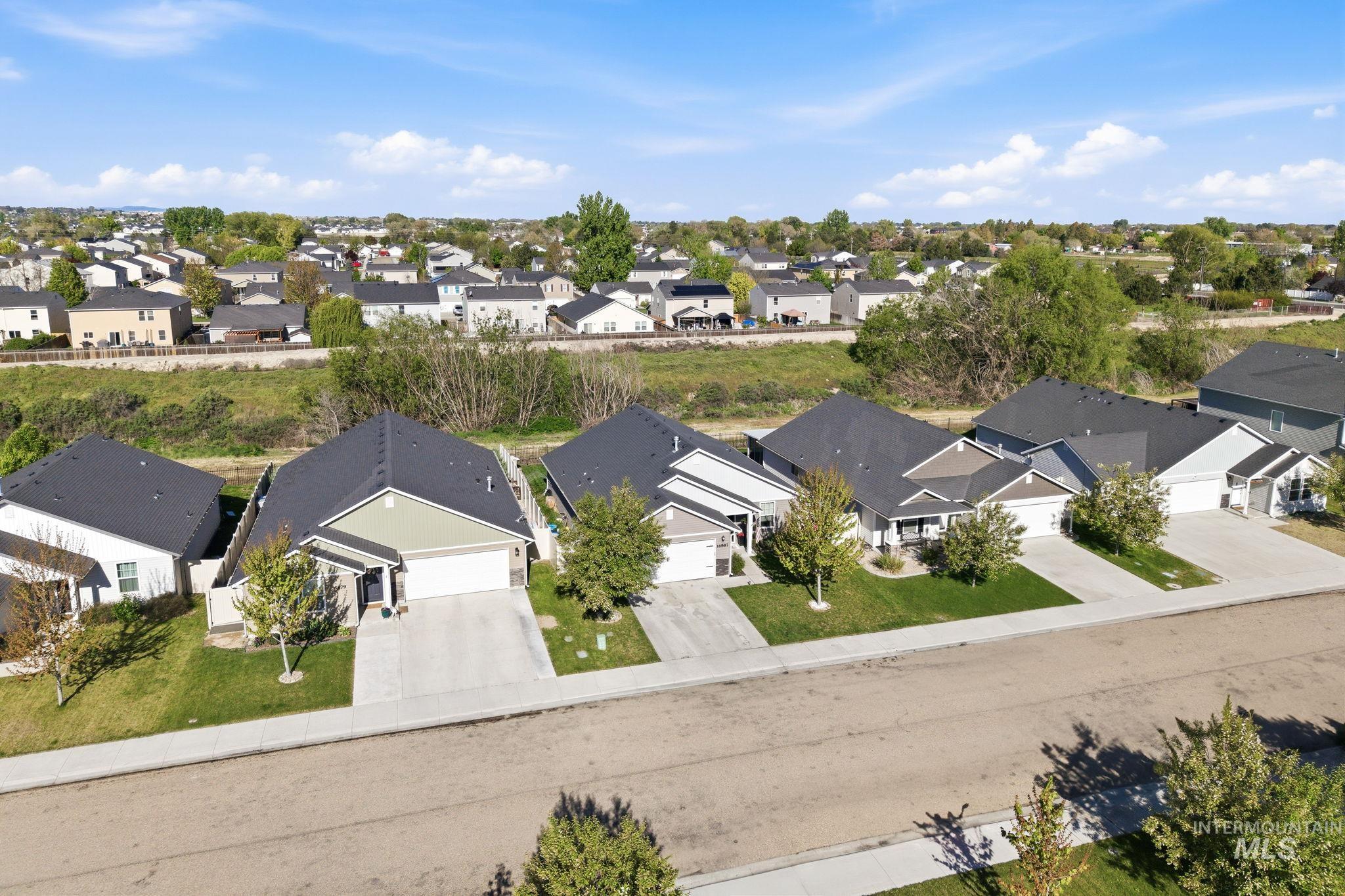16887 Bethany Avenue Caldwell, ID 83607 - Photo 49 of 50 Aerial perspective showcasing several single-story residences with attached garages and paved driveways