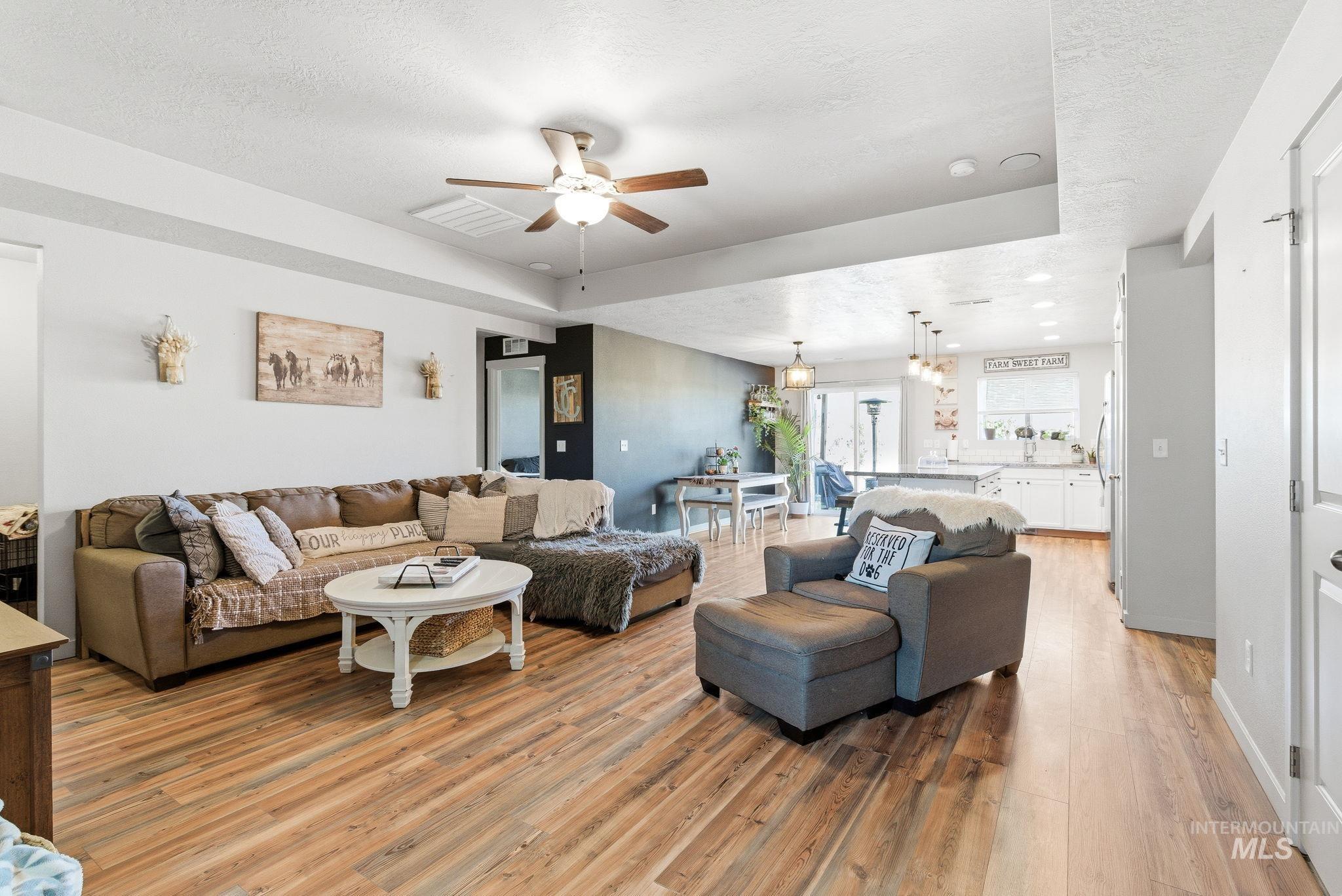 16887 Bethany Avenue Caldwell, ID 83607 - Photo 5 of 50 Open-concept living area with wood-finish flooring, a ceiling fan, and recessed lighting
