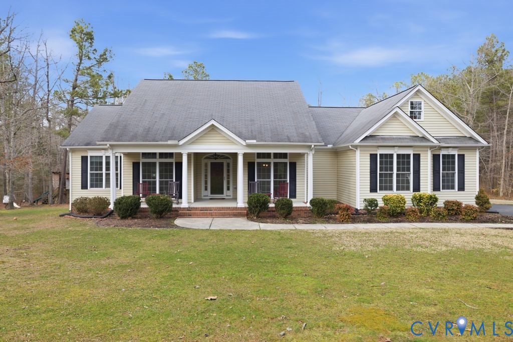 13630 River Road Chesterfield, VA 23838 - Photo 1 of 57 a front view of a house with a garden and porch