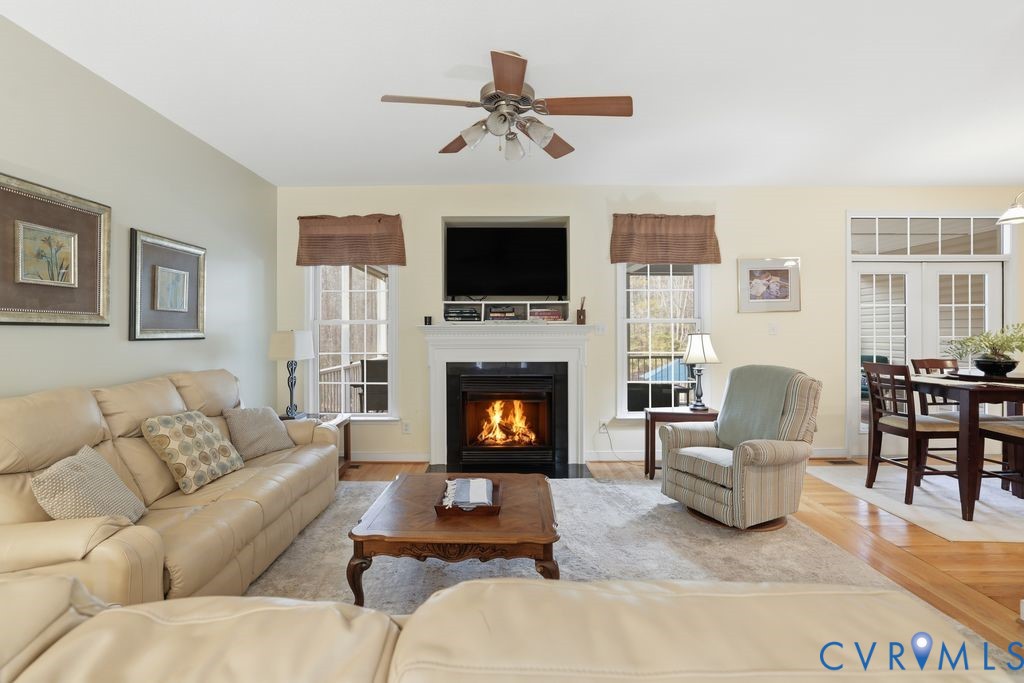 13630 River Road Chesterfield, VA 23838 - Photo 13 of 57 a living room with furniture a flat screen tv and a fireplace