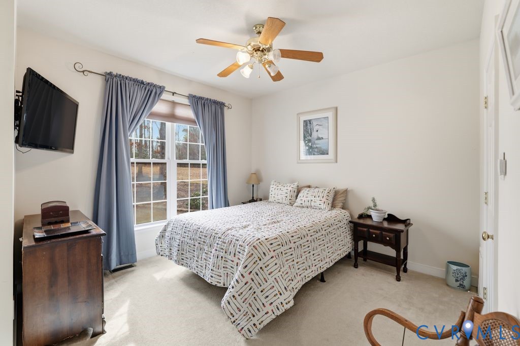 13630 River Road Chesterfield, VA 23838 - Photo 17 of 57 a bedroom with a bed and a flat screen tv