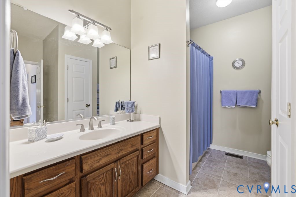 13630 River Road Chesterfield, VA 23838 - Photo 18 of 57 a bathroom with a sink double vanity and a mirror