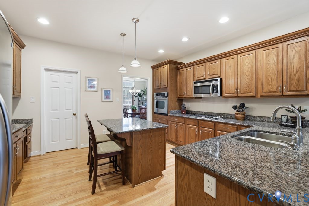 13630 River Road Chesterfield, VA 23838 - Photo 23 of 57 a kitchen with stainless steel appliances granite countertop a sink stove and refrigerator