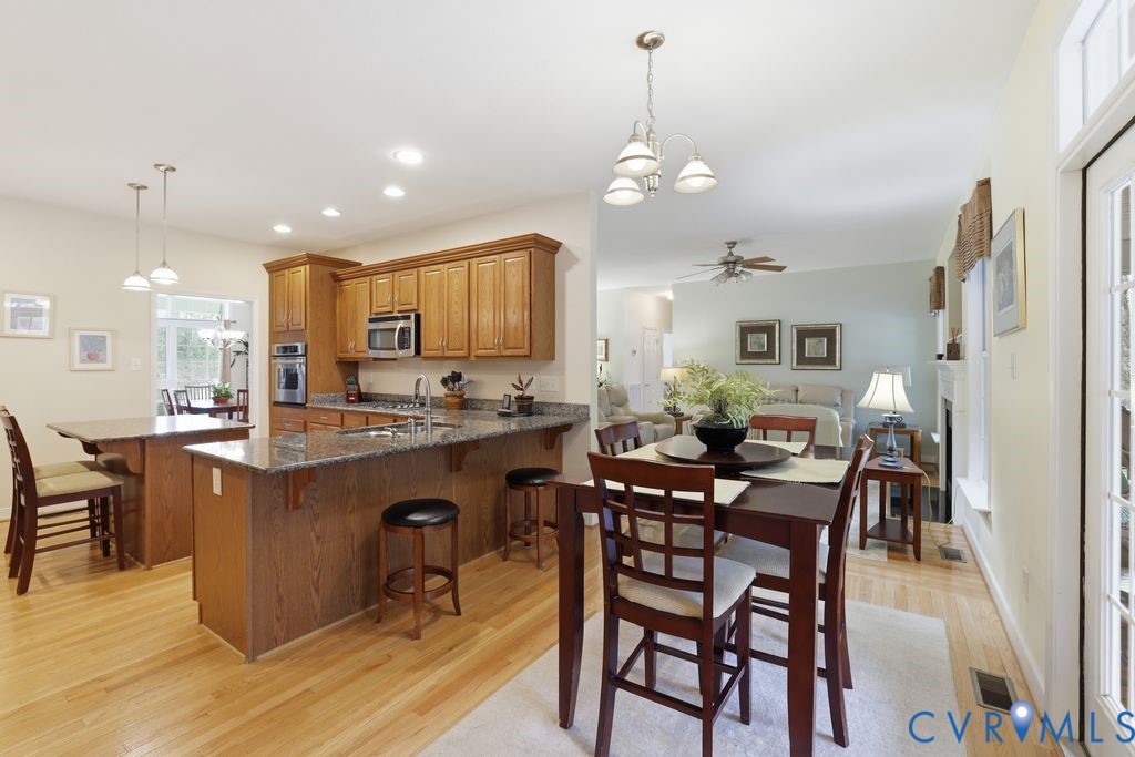 13630 River Road Chesterfield, VA 23838 - Photo 24 of 57 a view of a dining room with furniture and chandelier