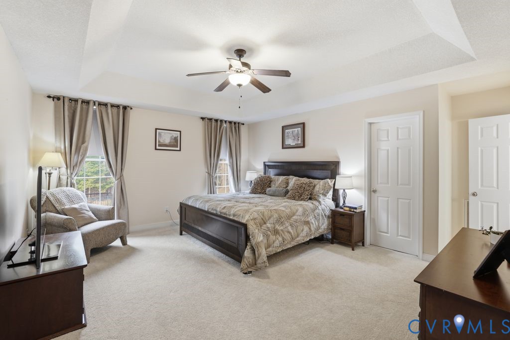 13630 River Road Chesterfield, VA 23838 - Photo 26 of 57 a spacious bedroom with a bed and a couch