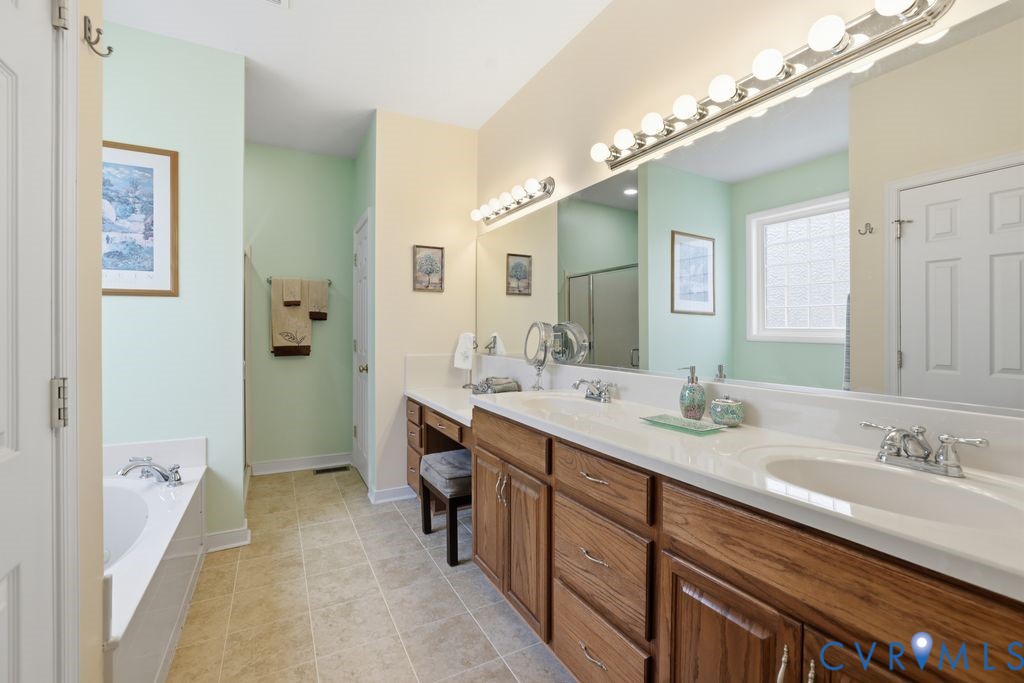 13630 River Road Chesterfield, VA 23838 - Photo 29 of 57 a spacious bathroom with a granite countertop double vanity sink a mirror and a