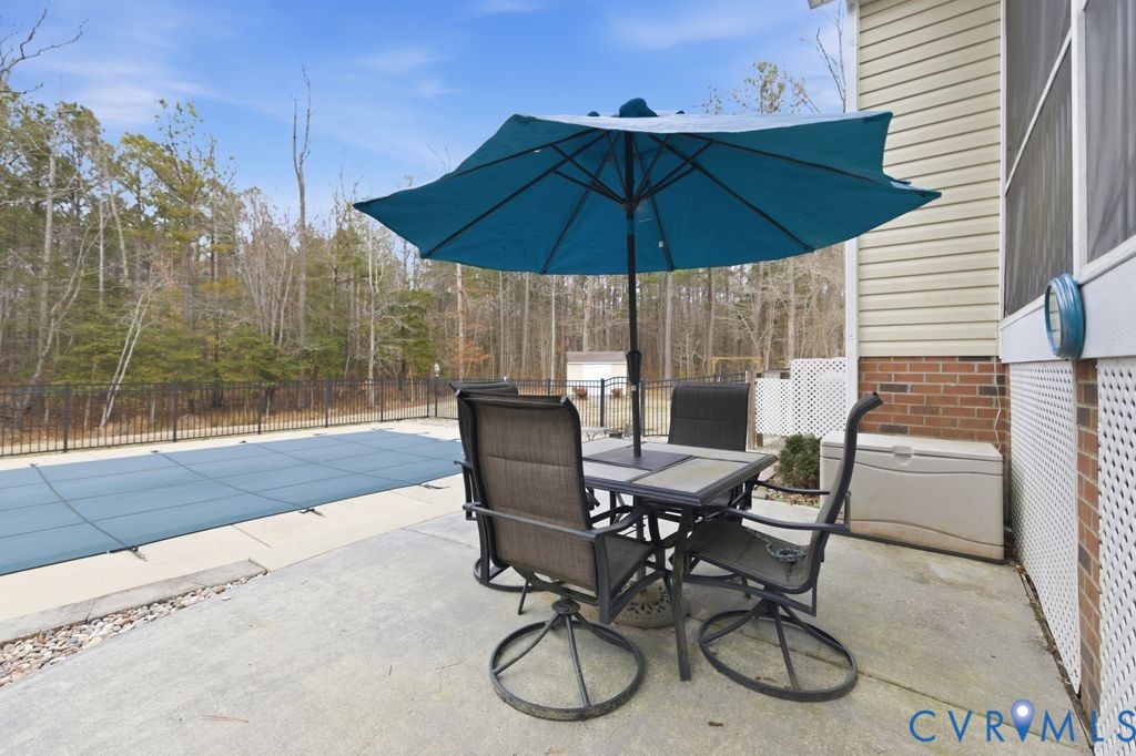 13630 River Road Chesterfield, VA 23838 - Photo 51 of 57 a patio with a patio table and chairs