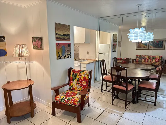 a dining room with furniture and a chandelier