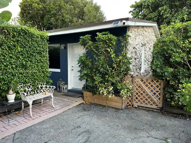 a view of a chair and table in the backyard