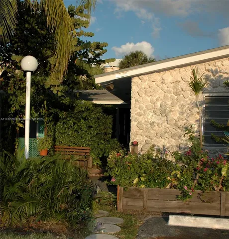 a front view of a house with yard and outdoor seating