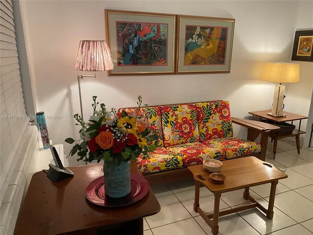 a vase of flowers sitting on a table with a rug