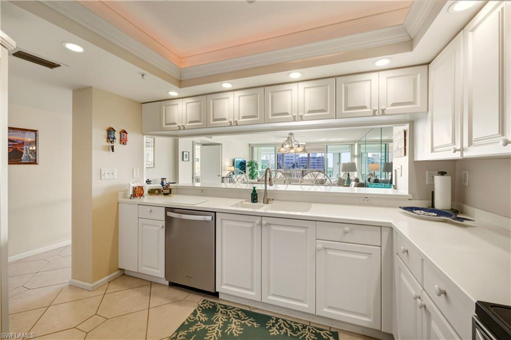 21 Bluebill Avenue, Unit 403B Naples, FL 34108 - Photo 15 of 37 a kitchen with stainless steel appliances granite countertop a sink and cabinets