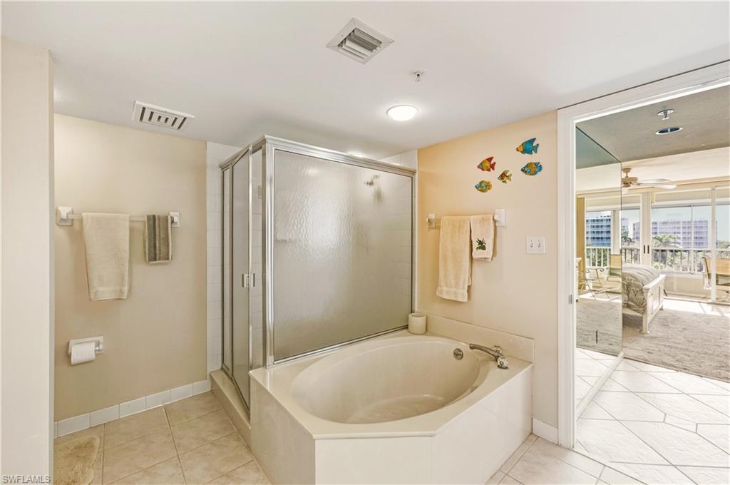 21 Bluebill Avenue, Unit 403B Naples, FL 34108 - Photo 20 of 37 a bathroom with a tub a sink and shower