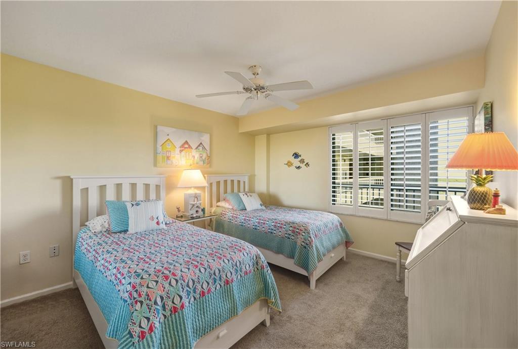 21 Bluebill Avenue, Unit 403B Naples, FL 34108 - Photo 21 of 37 a bedroom with bed and window