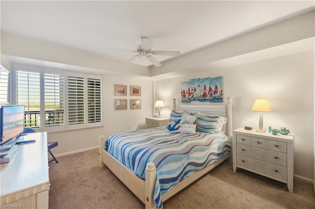 21 Bluebill Avenue, Unit 403B Naples, FL 34108 - Photo 22 of 37 a bedroom with a large bed and a window