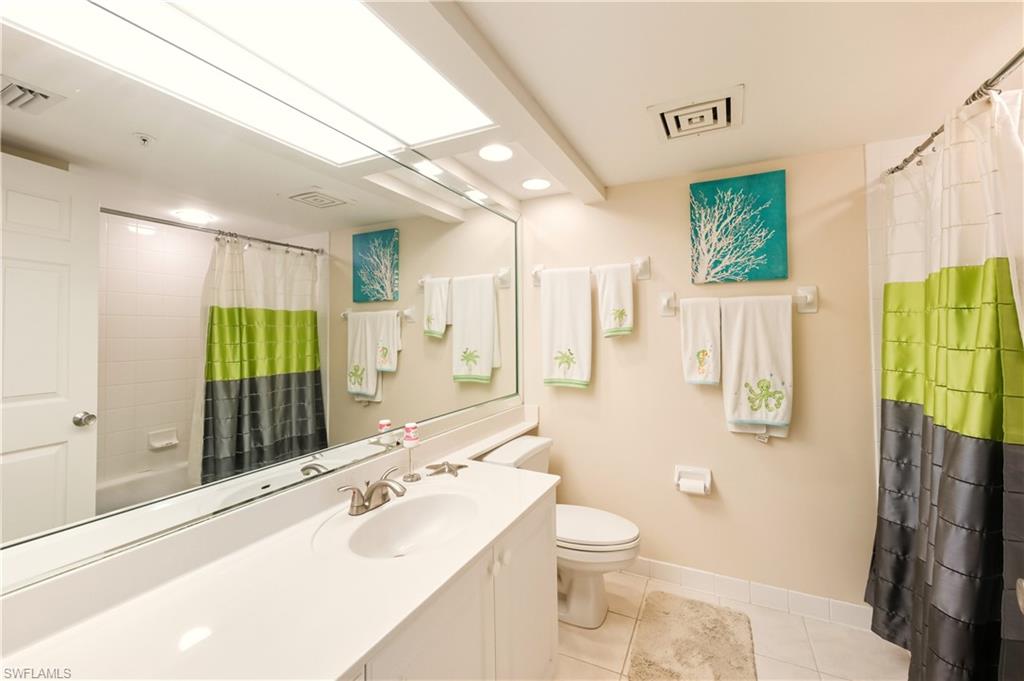 21 Bluebill Avenue, Unit 403B Naples, FL 34108 - Photo 24 of 37 a bathroom with a sink a toilet and shower