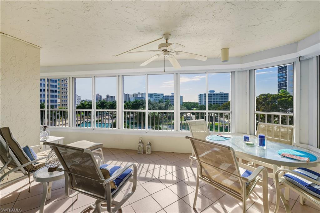 21 Bluebill Avenue, Unit 403B Naples, FL 34108 - Photo 26 of 37 a living room with furniture and large windows