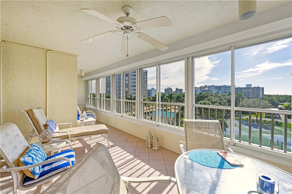 21 Bluebill Avenue, Unit 403B Naples, FL 34108 - Photo 27 of 37 a living room with furniture and floor to ceiling windows