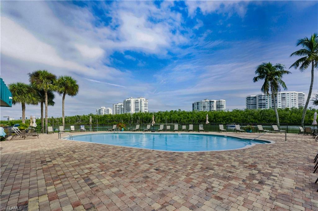 21 Bluebill Avenue, Unit 403B Naples, FL 34108 - Photo 30 of 37 a view of a swimming pool and a yard