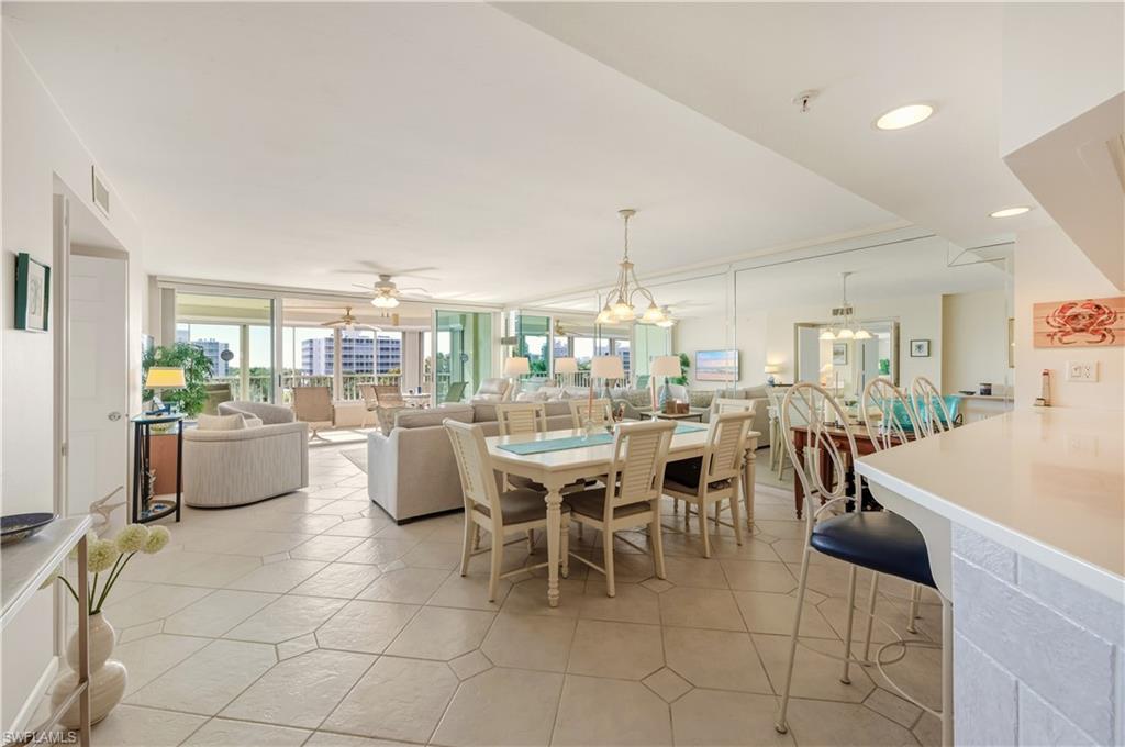 21 Bluebill Avenue, Unit 403B Naples, FL 34108 - Photo 3 of 37 a dining room with lots of tables and chairs