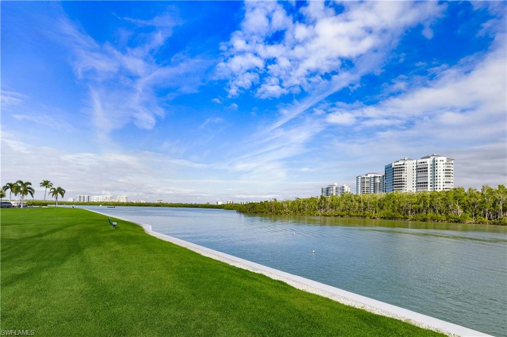 21 Bluebill Avenue, Unit 403B Naples, FL 34108 - Photo 36 of 37 a view of a lake with houses in the back