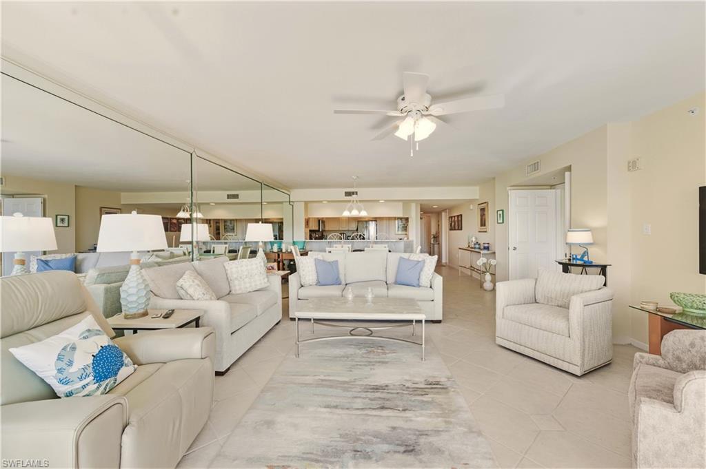 21 Bluebill Avenue, Unit 403B Naples, FL 34108 - Photo 7 of 37 a living room with furniture white walls and white walls
