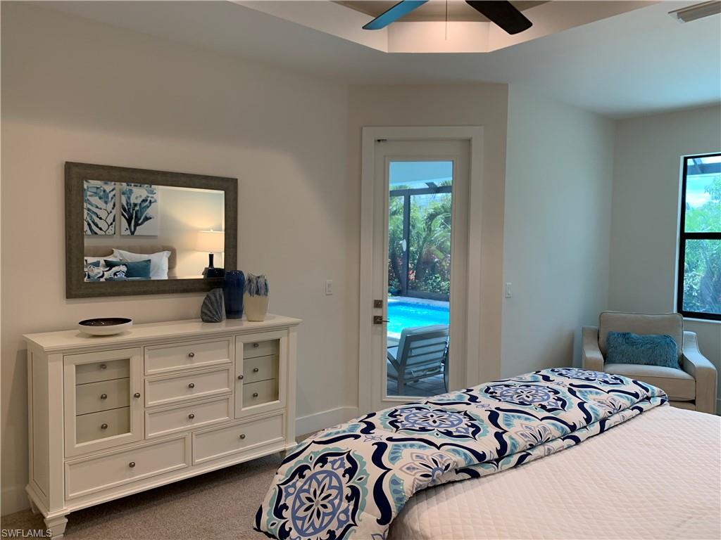 214 Legacy Court Naples, FL 34110 - Photo 23 of 49 a bedroom with a bed and a window