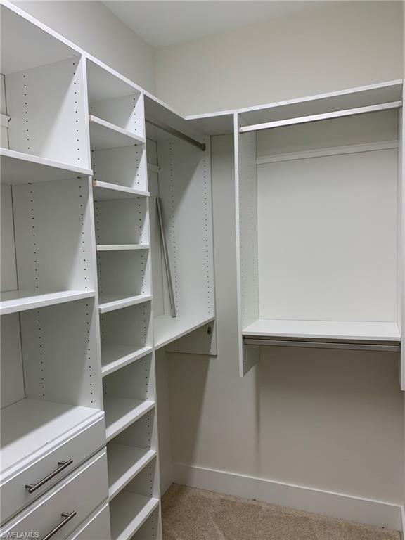 214 Legacy Court Naples, FL 34110 - Photo 25 of 49 a view of walk in closet with empty racks