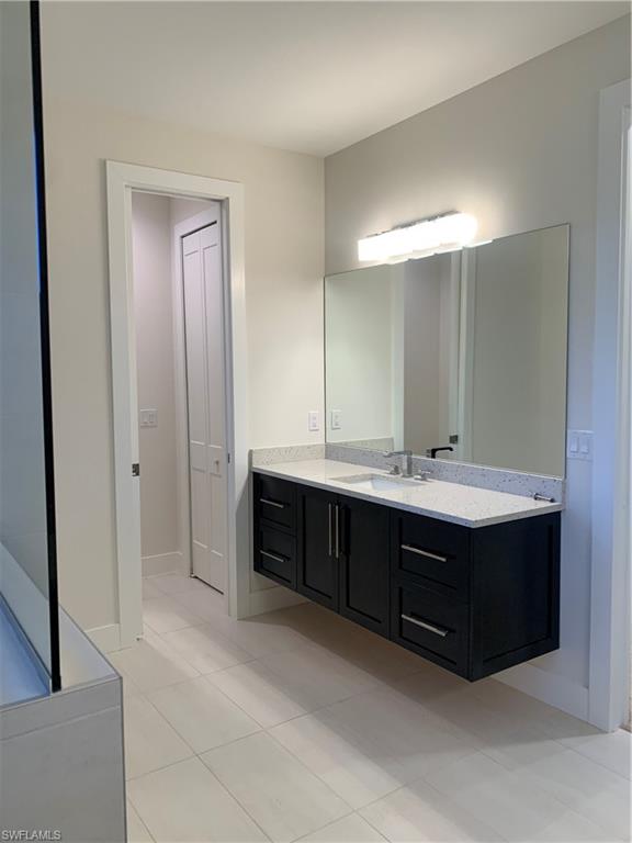 214 Legacy Court Naples, FL 34110 - Photo 28 of 49 a bathroom with a sink double vanity and a mirror