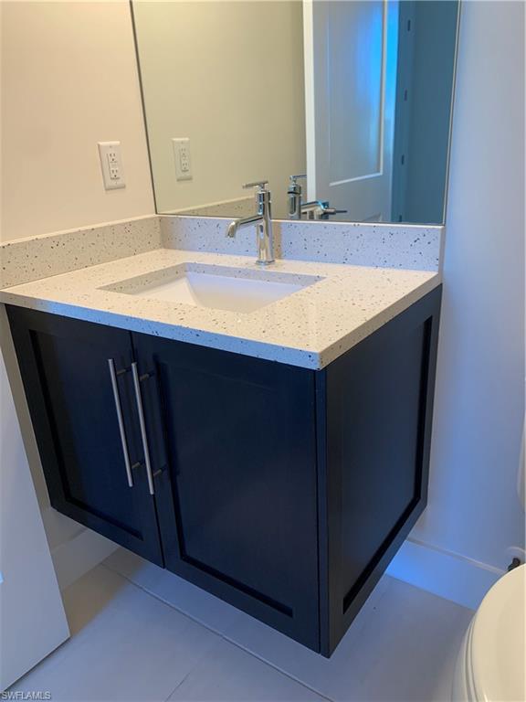 214 Legacy Court Naples, FL 34110 - Photo 37 of 49 a bathroom with a sink and a mirror