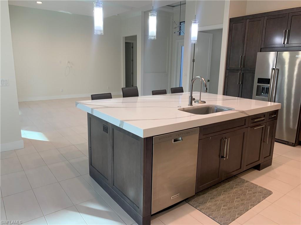 214 Legacy Court Naples, FL 34110 - Photo 39 of 49 a bathroom with a sink and a mirror