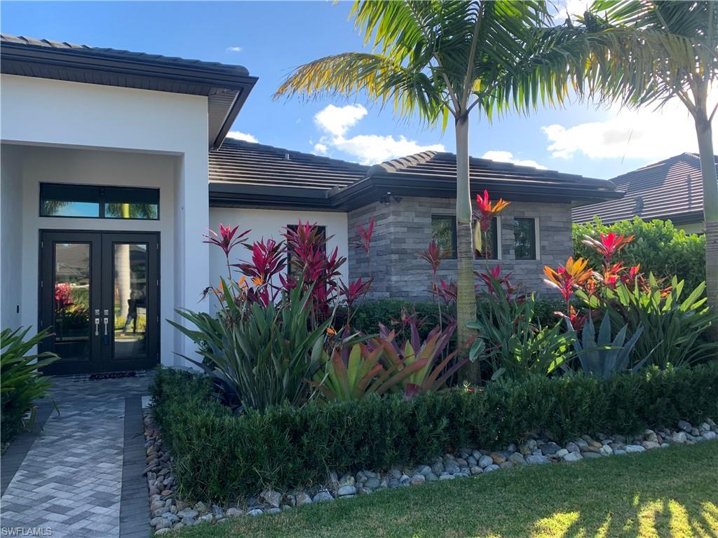 214 Legacy Court Naples, FL 34110 - Photo 4 of 49 a front view of house with yard and swimming pool