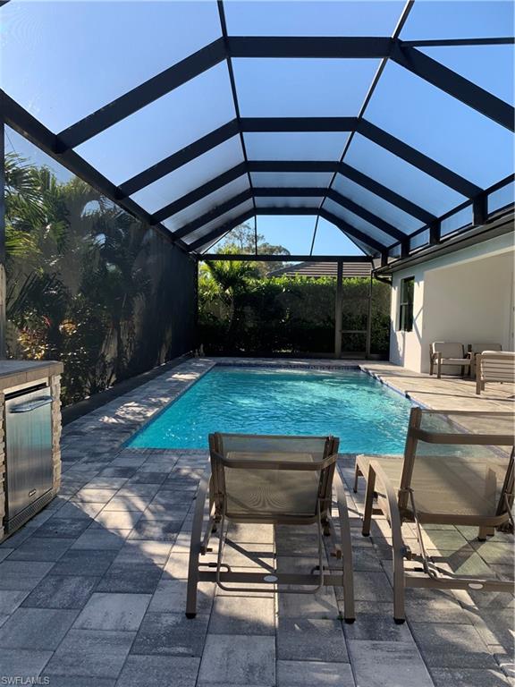 214 Legacy Court Naples, FL 34110 - Photo 42 of 49 a view of a backyard with sitting area