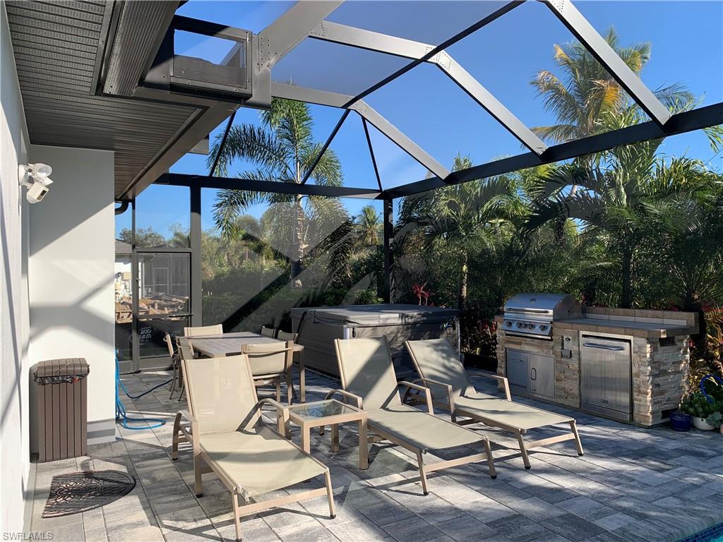 214 Legacy Court Naples, FL 34110 - Photo 43 of 49 SPA is on the pool deck just beyond the built in grill.