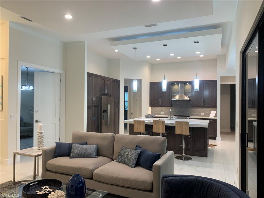 214 Legacy Court Naples, FL 34110 - Photo 49 of 49 a living room with stainless steel appliances kitchen island furniture and a view of kitchen
