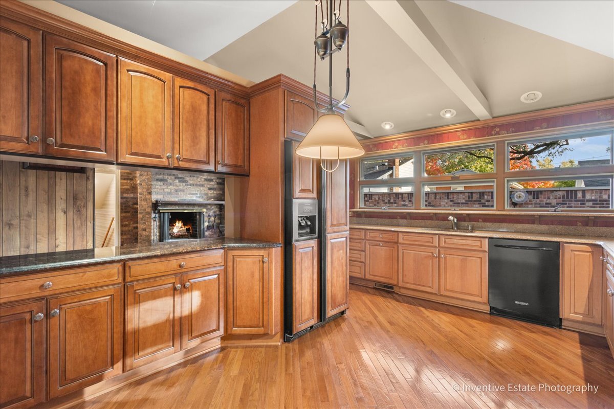 814 Saylor Avenue Elmhurst, IL 60126 - Photo 12 of 35 a kitchen with stainless steel appliances granite countertop a refrigerator a stove and a wooden floors