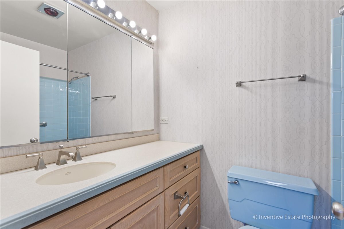 814 Saylor Avenue Elmhurst, IL 60126 - Photo 16 of 35 a bathroom with a sink a toilet and a mirror