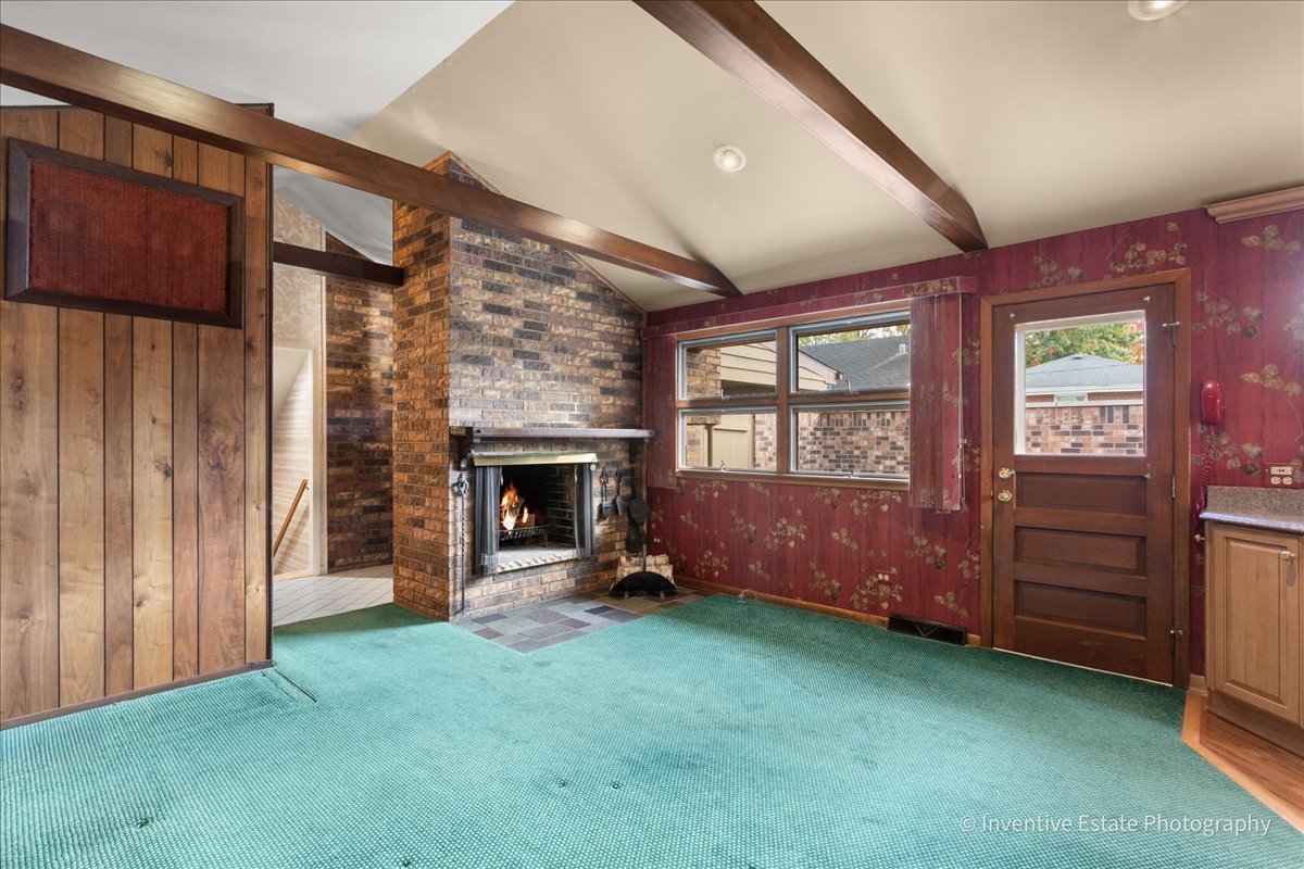 814 Saylor Avenue Elmhurst, IL 60126 - Photo 7 of 35 a view of an empty room with a fireplace and a window