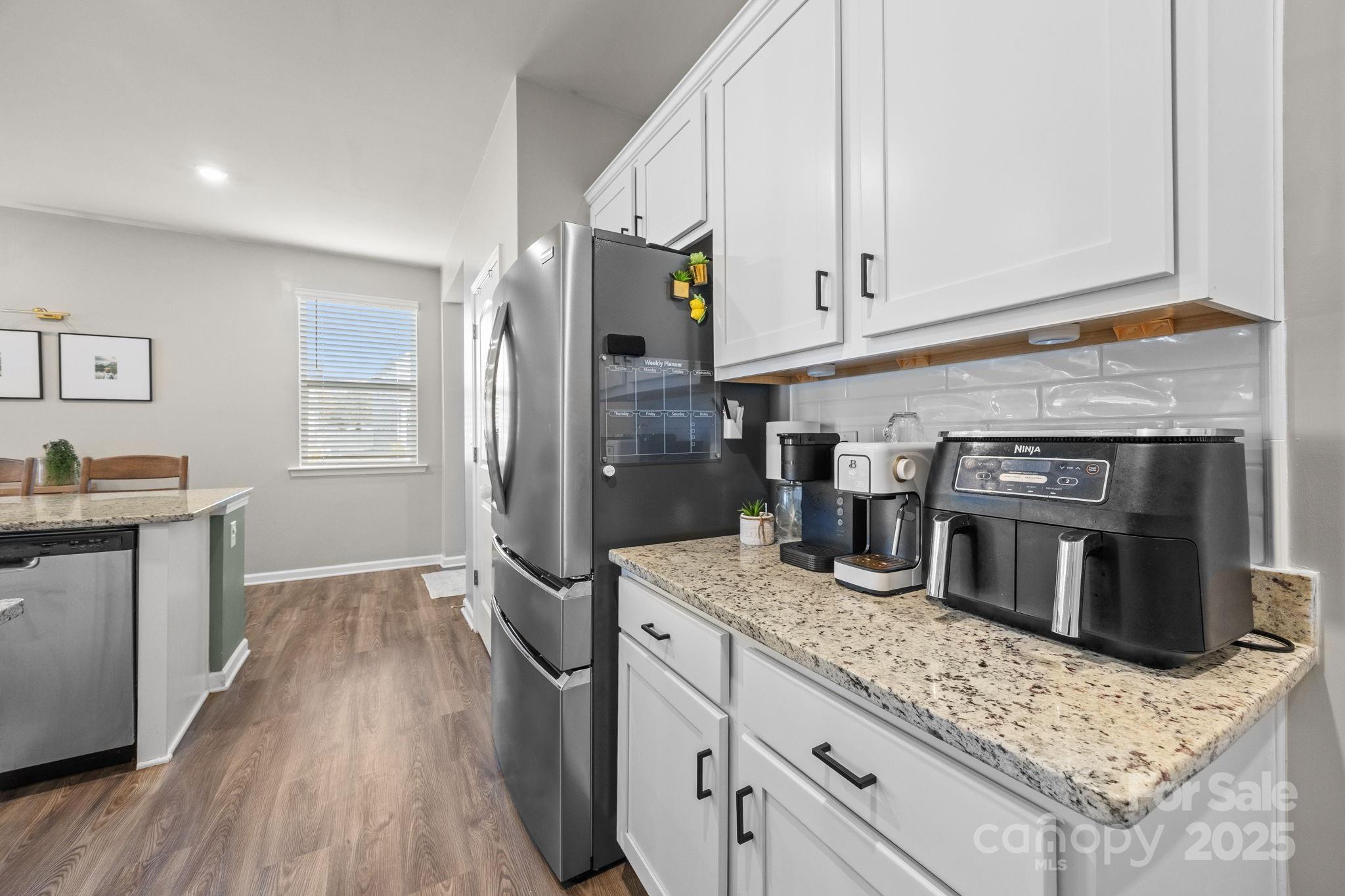 567 Sitka Drive York, SC 29745 - Photo 12 of 40 a kitchen with stainless steel appliances granite countertop a stove a sink and a refrigerator