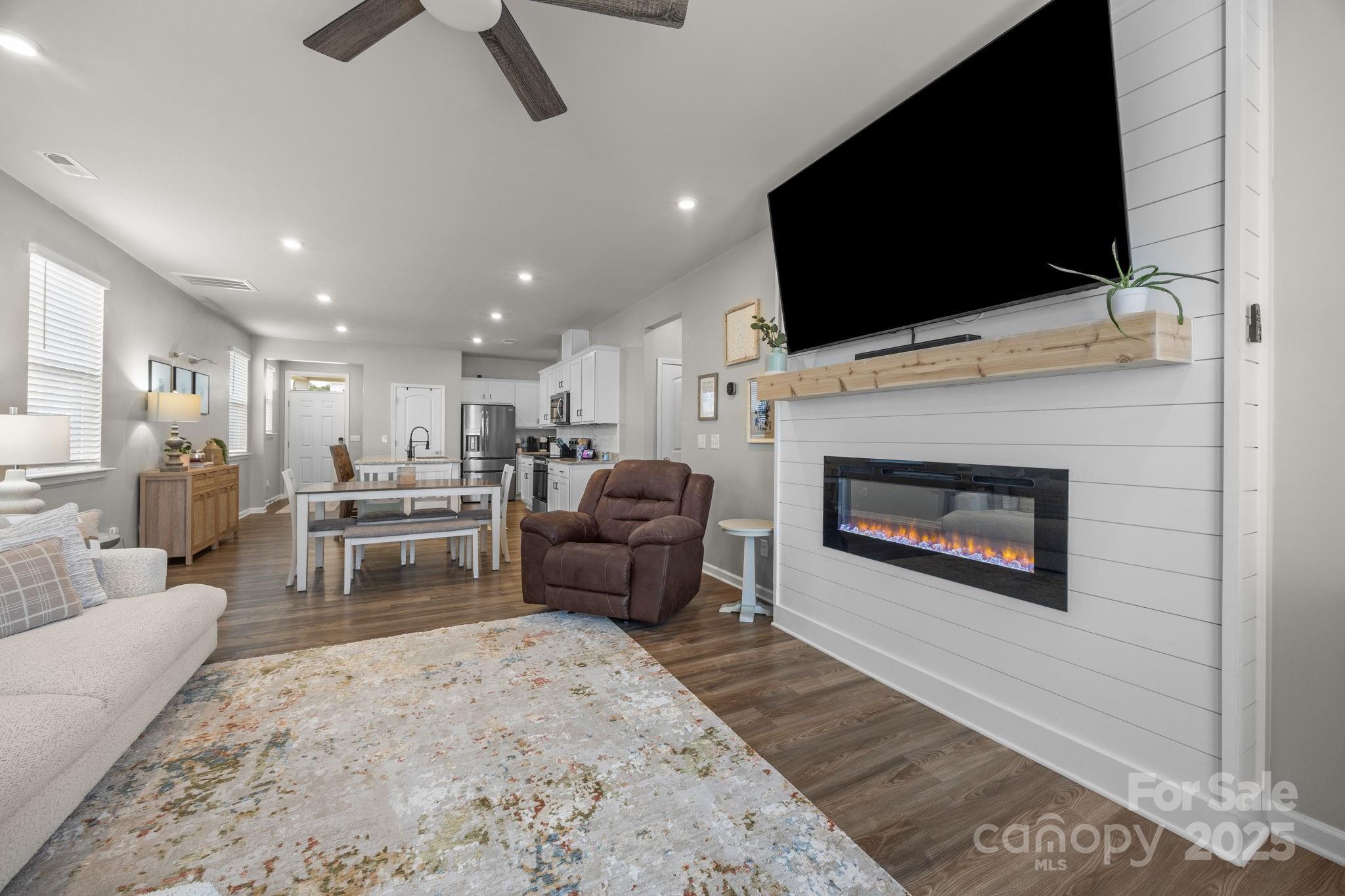 567 Sitka Drive York, SC 29745 - Photo 16 of 40 a living room with furniture a flat screen tv and a fireplace